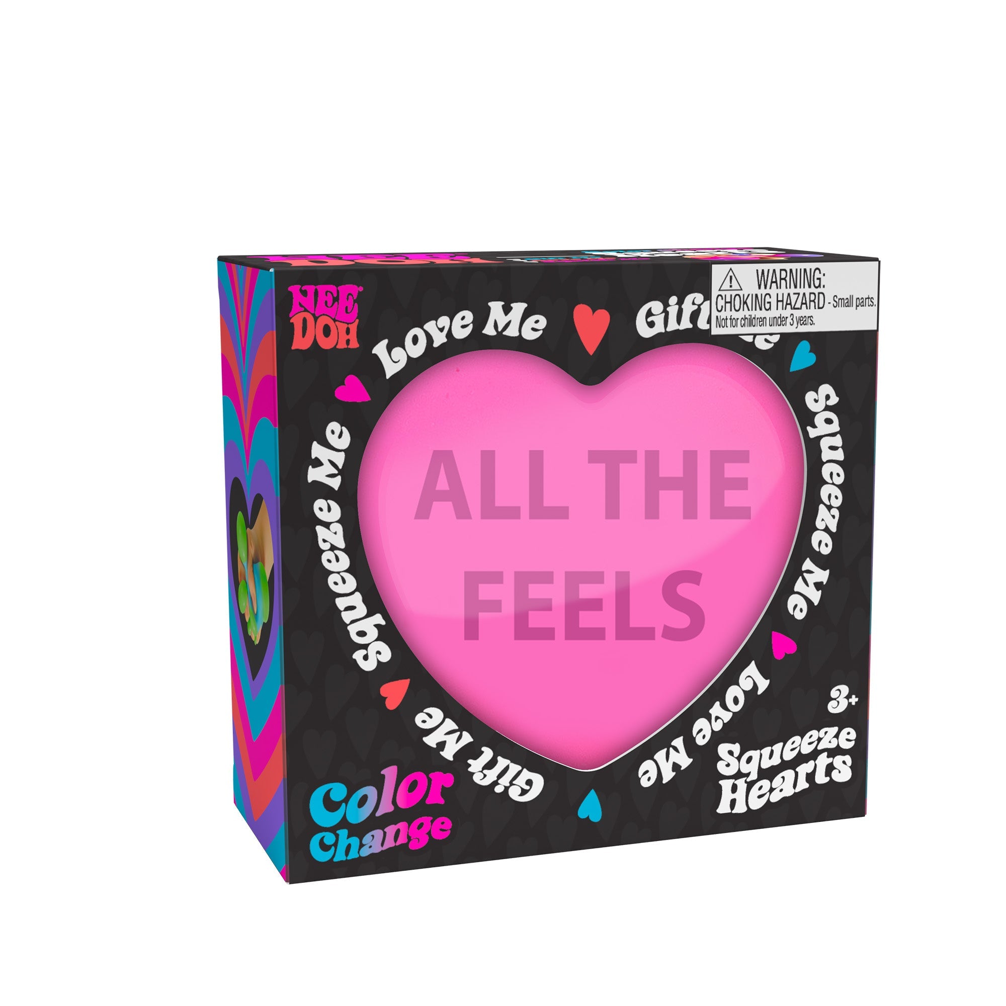 A boxed Nee Doh Color Change Squeeze Heart K3 toy. The packaging is predominantly black with colorful accents, featuring phrases like "ALL THE FEELS," "Squeeze Me," "Love Me," and "Gift Me." The box also includes a choking hazard warning for small parts.