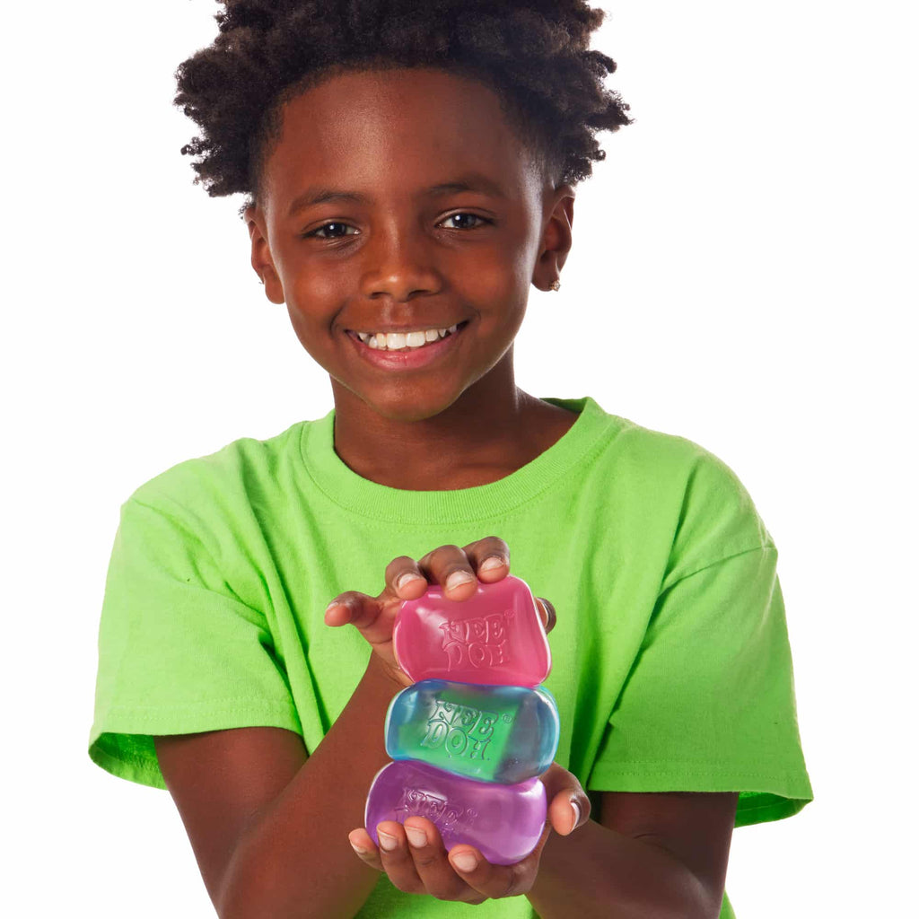 NeeDoh Nice Cube P2 Lifestyle of boy squeezing Nice Cube P2 stack