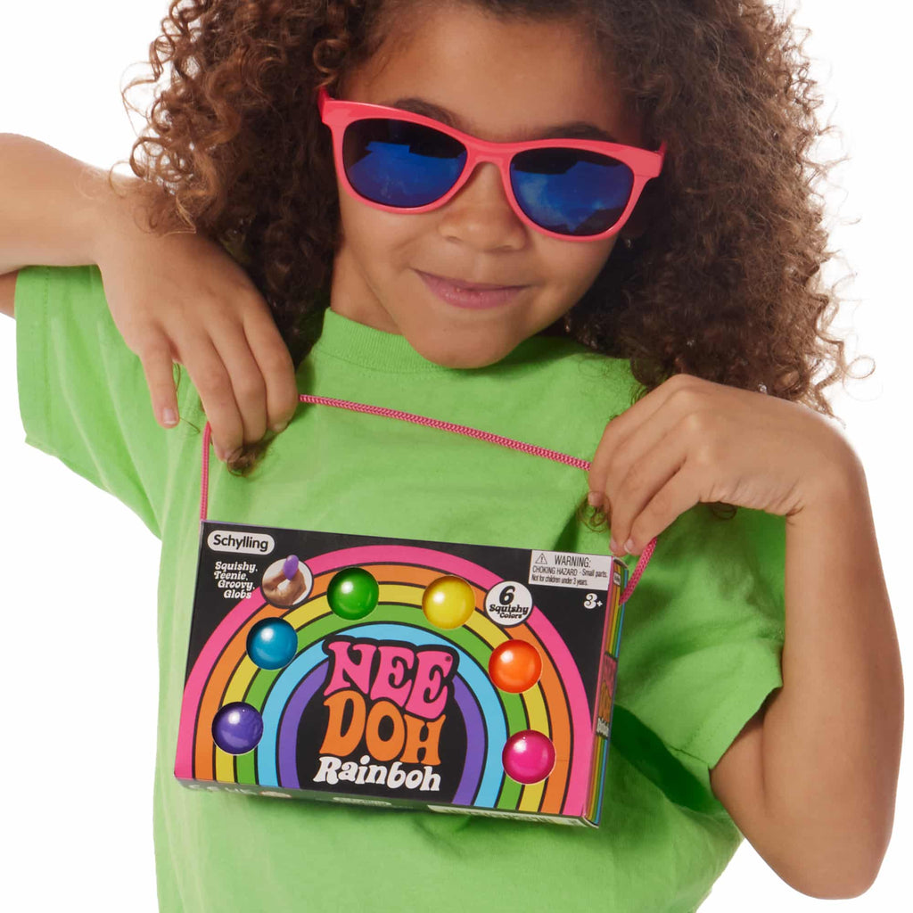 Girl holding the NeeDoh Rainboh W9 packaging
